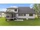 The back exterior features a screened-in porch with access steps, a concrete pad, and well-maintained landscaping at 525 Allesandra Dr, Clayton, NC 27527