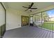 Covered screened-in porch with fan, overlooking level backyard at 525 Allesandra Dr, Clayton, NC 27527