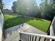 View of the spacious backyard with lush green grass and a line of trees at the property's edge at 525 Allesandra Dr, Clayton, NC 27527
