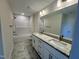 Bright bathroom featuring double sinks, marble floor, shower and bath with granite counter at 525 Allesandra Dr, Clayton, NC 27527