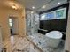 Stylish bathroom featuring a glass-enclosed shower, a soaking tub, and elegant tile work at 525 Allesandra Dr, Clayton, NC 27527