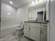 Bathroom features a tub with shower, single sink vanity and marble floors at 525 Allesandra Dr, Clayton, NC 27527