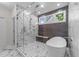 Bright bathroom featuring a soaking tub, glass shower with marble tile, and modern fixtures at 525 Allesandra Dr, Clayton, NC 27527