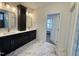 Elegant bathroom featuring double vanity, modern fixtures, and marble-look tile flooring at 525 Allesandra Dr, Clayton, NC 27527