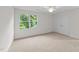 Bedroom has a view to lush greenery out a large window, ceiling fan, and a double closet at 525 Allesandra Dr, Clayton, NC 27527