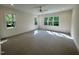 Sunlit bedroom with carpeted floors, a ceiling fan, and multiple windows with scenic views at 525 Allesandra Dr, Clayton, NC 27527
