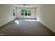 Spacious bedroom with carpeted floors and windows providing natural light and exterior views at 525 Allesandra Dr, Clayton, NC 27527