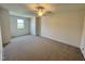 Spacious bedroom with plush carpeting, ceiling fan, and a window offering natural light at 525 Allesandra Dr, Clayton, NC 27527
