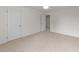 Spacious bedroom with neutral carpet, a ceiling fan, and doors at 525 Allesandra Dr, Clayton, NC 27527
