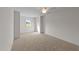 Spacious bedroom with neutral carpet, ceiling fan, a window, and blank white walls at 525 Allesandra Dr, Clayton, NC 27527