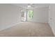 Bedroom features neutral carpet and a bathroom visible through an open doorway at 525 Allesandra Dr, Clayton, NC 27527