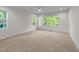 Bright, spacious bedroom with large windows offering natural light and a view of the surrounding landscape at 525 Allesandra Dr, Clayton, NC 27527