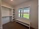 Walk-in closet with built-in shelving and a window providing natural light and a view of the outdoors at 525 Allesandra Dr, Clayton, NC 27527
