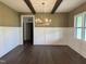 Elegant dining room with dark hardwood floors, stylish chandelier, and white wainscoting at 525 Allesandra Dr, Clayton, NC 27527