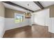An elegant dining room with hardwood floors, wainscoting, wood beams and ample light at 525 Allesandra Dr, Clayton, NC 27527