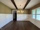 Elegant dining room with dark hardwood floors, stylish chandelier, and white wainscoting at 525 Allesandra Dr, Clayton, NC 27527