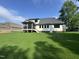 Rear view of the house from the large backyard showing screened porch and white siding at 525 Allesandra Dr, Clayton, NC 27527