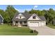 Charming home features a two-car garage, stone accents and a well-manicured lawn at 525 Allesandra Dr, Clayton, NC 27527