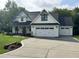 Charming two-story home with a well-manicured lawn and an attached two-car garage at 525 Allesandra Dr, Clayton, NC 27527