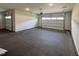A spacious garage with concrete floors and two white garage doors, offering ample parking at 525 Allesandra Dr, Clayton, NC 27527