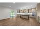 Open kitchen with island, modern appliances, and access to deck at 525 Allesandra Dr, Clayton, NC 27527