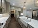 Elegant kitchen boasts hidden pantry, white countertops, and stainless steel appliances at 525 Allesandra Dr, Clayton, NC 27527