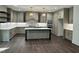 Large kitchen features island, white backsplash, wood floors, and stainless appliances at 525 Allesandra Dr, Clayton, NC 27527