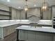 Modern kitchen with island, stone countertops, pendant lights, and stainless appliances at 525 Allesandra Dr, Clayton, NC 27527