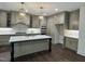 Bright, modern kitchen with island, stone countertops, and stainless steel appliances at 525 Allesandra Dr, Clayton, NC 27527