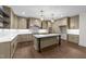 Gourmet kitchen with island, stainless steel appliances, and custom cabinetry at 525 Allesandra Dr, Clayton, NC 27527