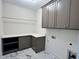 Neat laundry room with extra storage and a gray painted cabinet at 525 Allesandra Dr, Clayton, NC 27527