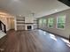Bright living room with hardwood floors, fireplace, and natural light from large windows overlooking the landscape at 525 Allesandra Dr, Clayton, NC 27527