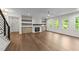 Bright living room with fireplace, built-in shelves, and hardwood floors at 525 Allesandra Dr, Clayton, NC 27527