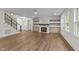 Inviting living room with fireplace, shelving, and stairs at 525 Allesandra Dr, Clayton, NC 27527