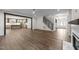 Open-concept living room with wood floors and view to kitchen at 525 Allesandra Dr, Clayton, NC 27527