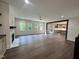 Spacious living room with fireplace, hardwood floors, and large windows, seamlessly connecting to the kitchen at 525 Allesandra Dr, Clayton, NC 27527