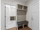 Convenient mudroom entryway with coat hooks and storage cubbies, adjacent to the modern laundry room at 525 Allesandra Dr, Clayton, NC 27527