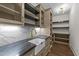 Walk-in pantry features shelves, a prep sink, and an expansive countertop with designer touches at 525 Allesandra Dr, Clayton, NC 27527