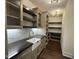 Beautiful pantry with a farmhouse sink, open shelving, and ample cabinet space at 525 Allesandra Dr, Clayton, NC 27527