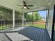 Screened in porch featuring a ceiling fan, black railings, and views of the backyard at 525 Allesandra Dr, Clayton, NC 27527
