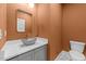 A modern powder room with a vessel sink, gold fixtures, and a decorative mirror at 525 Allesandra Dr, Clayton, NC 27527