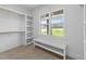 Walk-in closet with carpet, shelving, storage and a window overlooking the front yard at 525 Allesandra Dr, Clayton, NC 27527