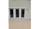 An outdoor back porch featuring a light wooden deck and white doors leading inside the house at 5401 Lower Creek Ct, Apex, NC 27539
