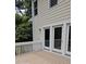A lovely back porch featuring a light wooden deck with white railings and doors leading inside the house at 5401 Lower Creek Ct, Apex, NC 27539
