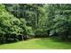 Lush backyard surrounded by greenery, creating a private outdoor sanctuary at 5401 Lower Creek Ct, Apex, NC 27539