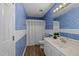 Bathroom featuring neutral carpet, textured blue wallpaper and a vanity with storage at 5401 Lower Creek Ct, Apex, NC 27539