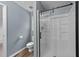Updated bathroom features a glass-enclosed shower, toilet, and modern fixtures, all with new flooring at 5401 Lower Creek Ct, Apex, NC 27539