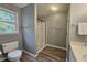 Neutral-toned bathroom featuring modern shower, toilet and vanity, all with updated flooring at 5401 Lower Creek Ct, Apex, NC 27539