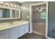 Well-lit bathroom featuring a modern vanity and luxury vinyl plank flooring at 5401 Lower Creek Ct, Apex, NC 27539