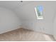 Well-lit carpeted bedroom featuring a skylight, electrical outlets and white walls at 5401 Lower Creek Ct, Apex, NC 27539